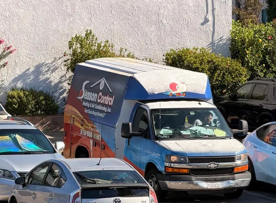 Season Control Heating & Air Conditioning service van arriving at a residential job site