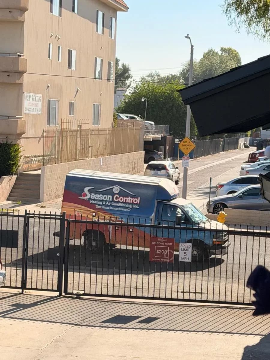 Season Control service van at an apartment complex gate for a scheduled HVAC visit